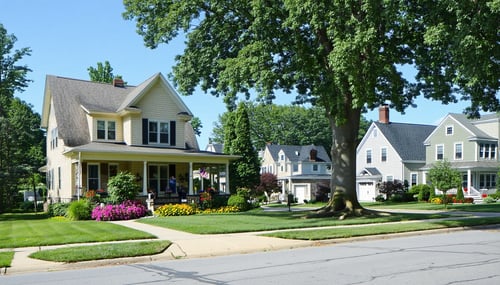 The image depicts a serene suburban neighborhood in Clayton County with neatly manicured lawns and a variety of architectural styles In the foreground a charming singlefamily home stands prominently showcasing a wellmaintained facade with a welcoming